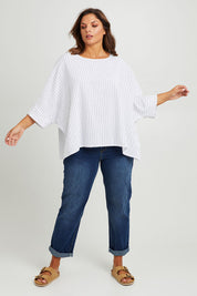 Model Monique wearing size 14 of the Joy And Laughter Slouch Top in colour Whitestrip (White), from the front, showing the whole outfit