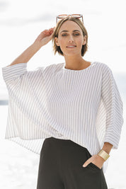 Model Tegan wearing size 10 of the Joy And Laughter Slouch Top in colour Whitestrip (White), from the front, showing the whole outfit