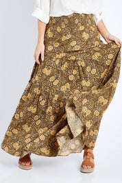 Model Laura wearing size 14 of the Skirting Around The Garden Skirt in colour Khakigold (Green), from the front, cropped image