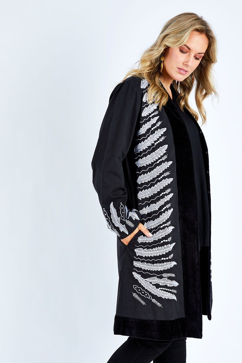 Model Jess wearing size 14 of the Flight Of The Feather Embroidered Jacket in colour Storm (Black), from the front, cropped image