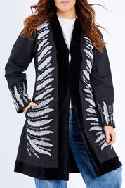 Model Laura wearing size 14 of the Flight Of The Feather Embroidered Jacket in colour Storm (Black), from the front, cropped image