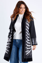 Model Laura wearing size 14 of the Flight Of The Feather Embroidered Jacket in colour Storm (Black), from the front, cropped image