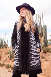 Model Marnee wearing size 10 of the Flight Of The Feather Embroidered Jacket in colour Storm (Black), from the front, showing the whole outfit