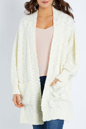 Model Elhana wearing size S of the Mountain Dreaming Cardi in colour Cream (White), from the front, cropped image
