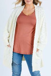 Model Jess wearing size L of the Mountain Dreaming Cardi in colour Cream (White), from the front, cropped image