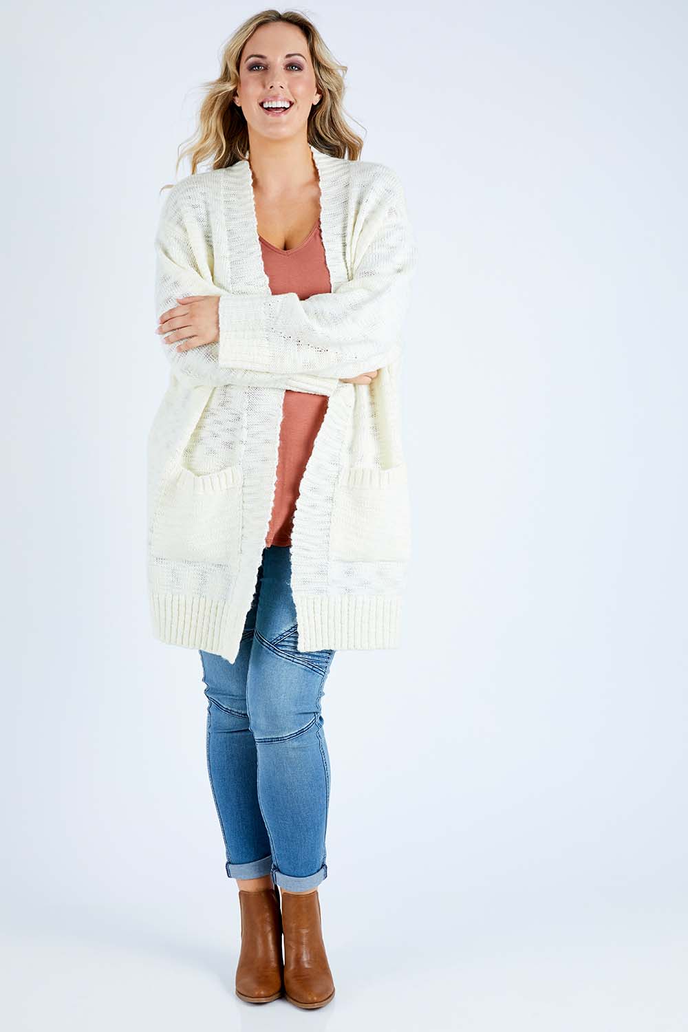 Model Jess wearing size L of the Mountain Dreaming Cardi in colour Cream (White), from the front, showing the whole outfit