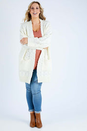 Model Jess wearing size L of the Mountain Dreaming Cardi in colour Cream (White), from the front, showing the whole outfit