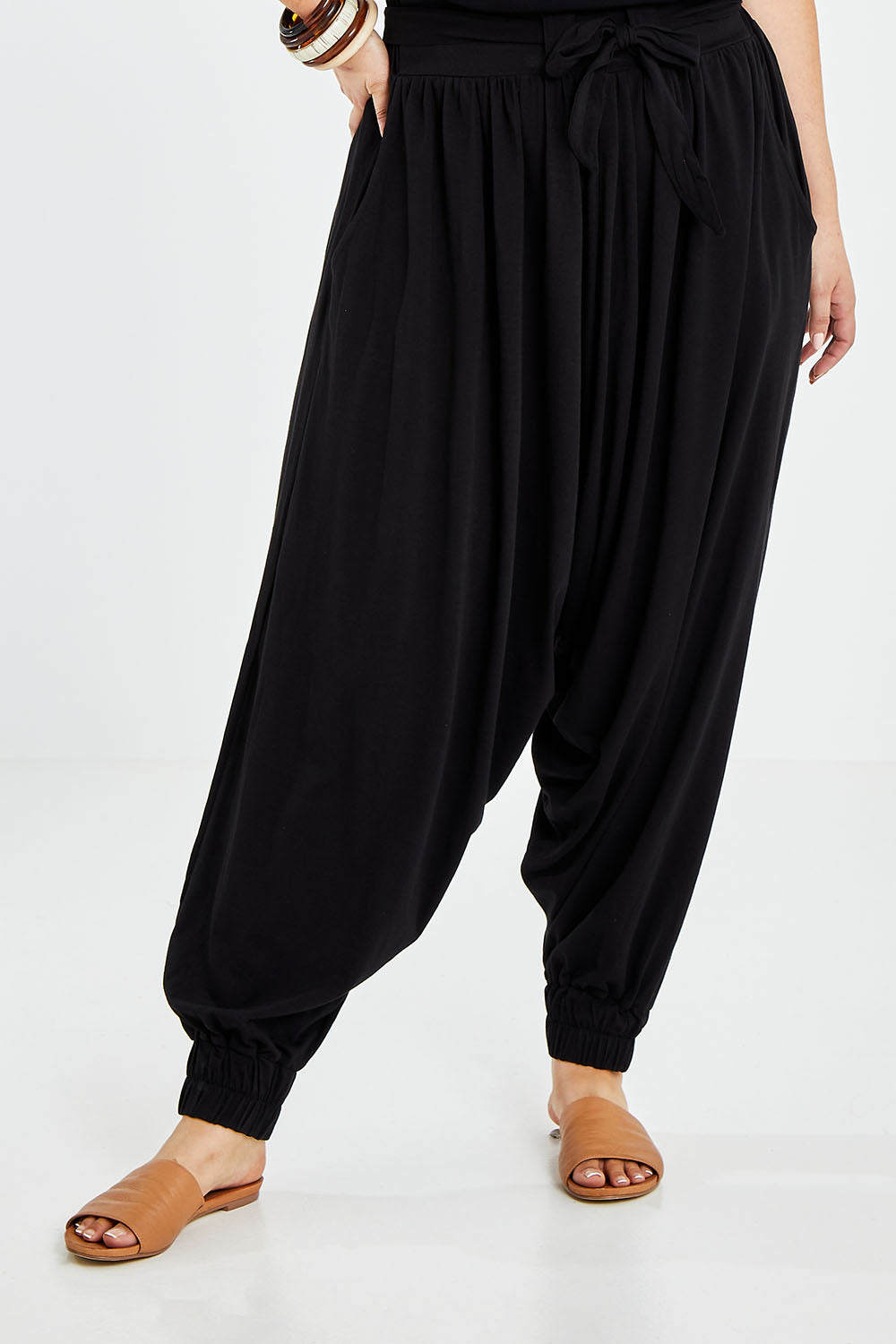 Model Jess wearing size 14 of the Relax With Me Slouch Pants in colour Black (Black), from the front, cropped image