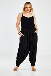Model Jess wearing size 14 of the Relax With Me Slouch Pants in colour Black (Black), from the front, showing the whole outfit
