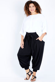 Model Jess wearing size 16 of the Relax With Me Slouch Pants in colour Black (Black), from the front, showing the whole outfit