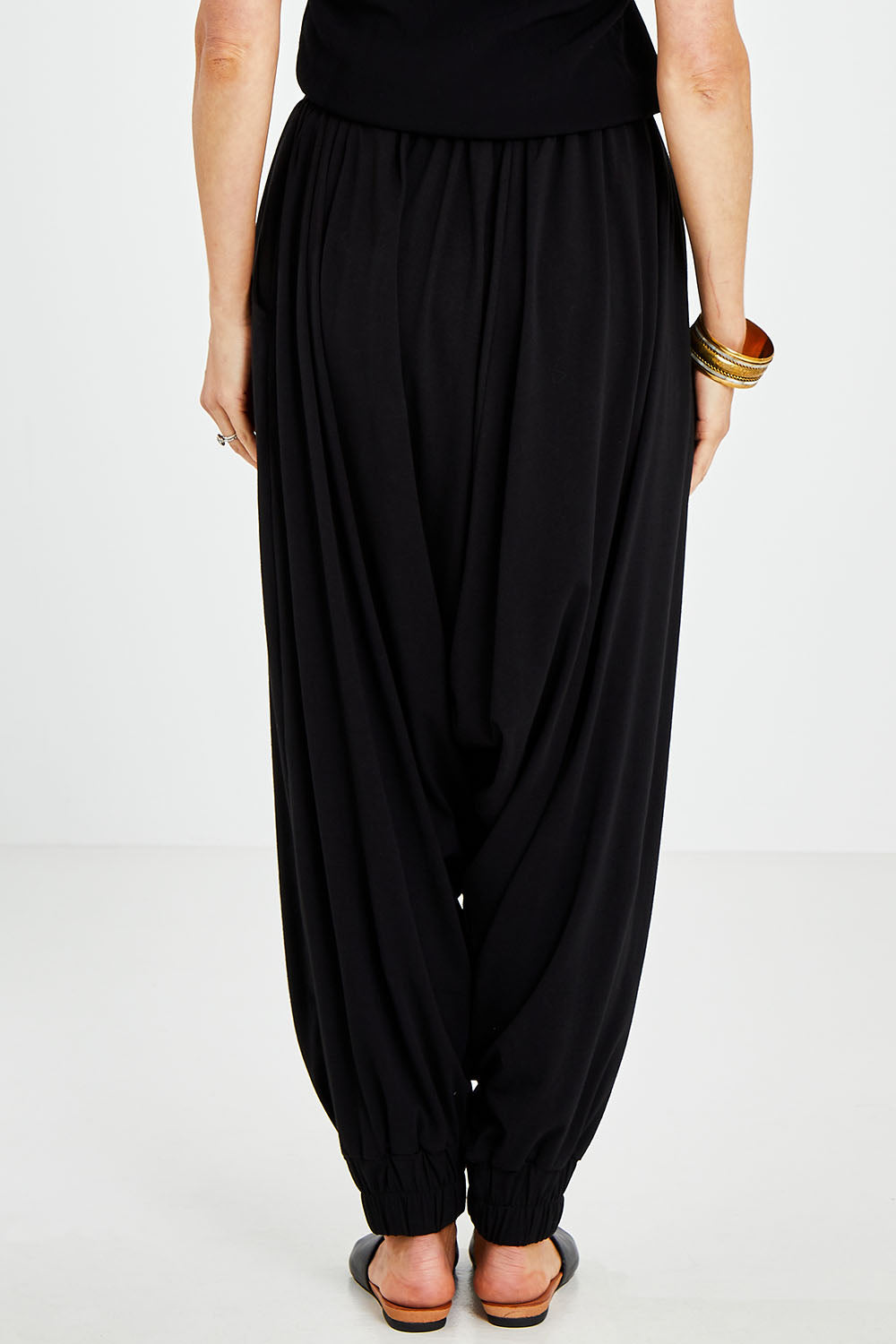 Model Kelly wearing size 10 of the Relax With Me Slouch Pants in colour Black (Black), from the back