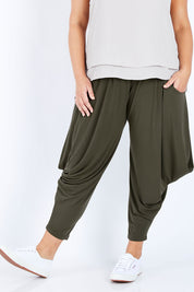 Model Jess wearing size 16 of The Wanderer In Me Travel Pant in colour Khaki (Green), from the front, cropped image