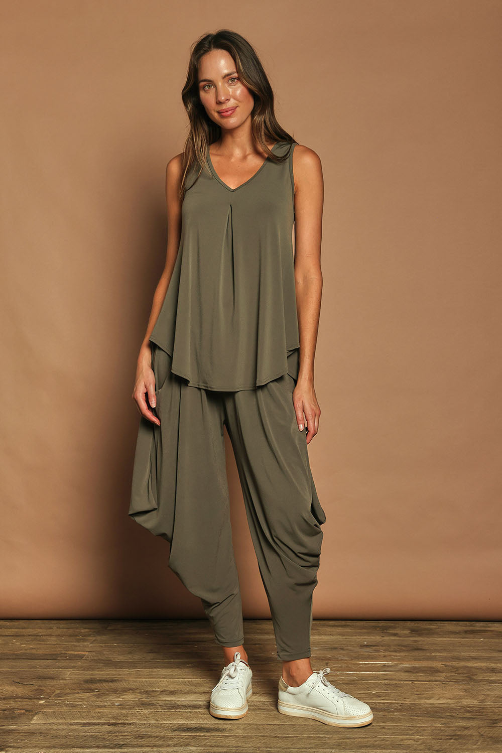 Model Madeline wearing size 10 of The Wanderer In Me Travel Pant in colour Khaki (Green), from the front, showing the whole outfit