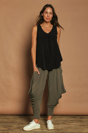 Model Madeline wearing size 10 of The Wanderer In Me Travel Pant in colour Khaki (Green), from the front, showing the whole outfit