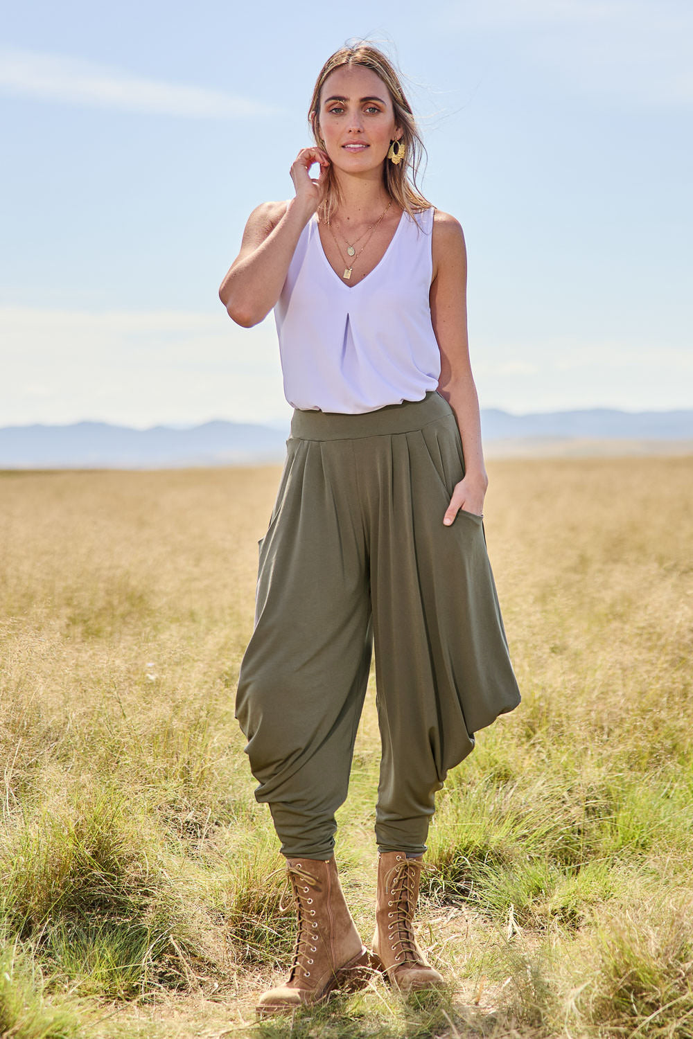 Model Tegan wearing size 10 of The Wanderer In Me Travel Pant in colour Khaki (Green), from the front, showing the whole outfit