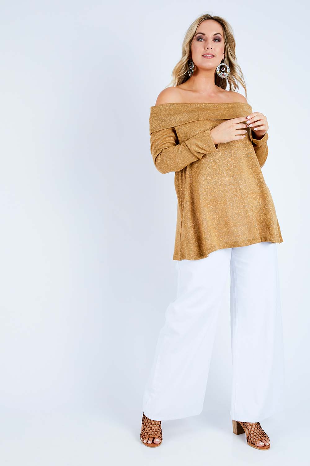 Model Jess wearing size 14 of the Shine Bright Off The Shoulder Top in colour Gold (Metallics), from the front, showing the whole outfit