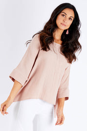 Model Chelsea wearing size 10 of the Flow With Me Cotton Slouch Top in colour Petal (Pink), from the front, cropped image