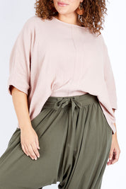 Model Jess wearing size 16 of the Flow With Me Cotton Slouch Top in colour Petal (Pink), from the front, cropped image