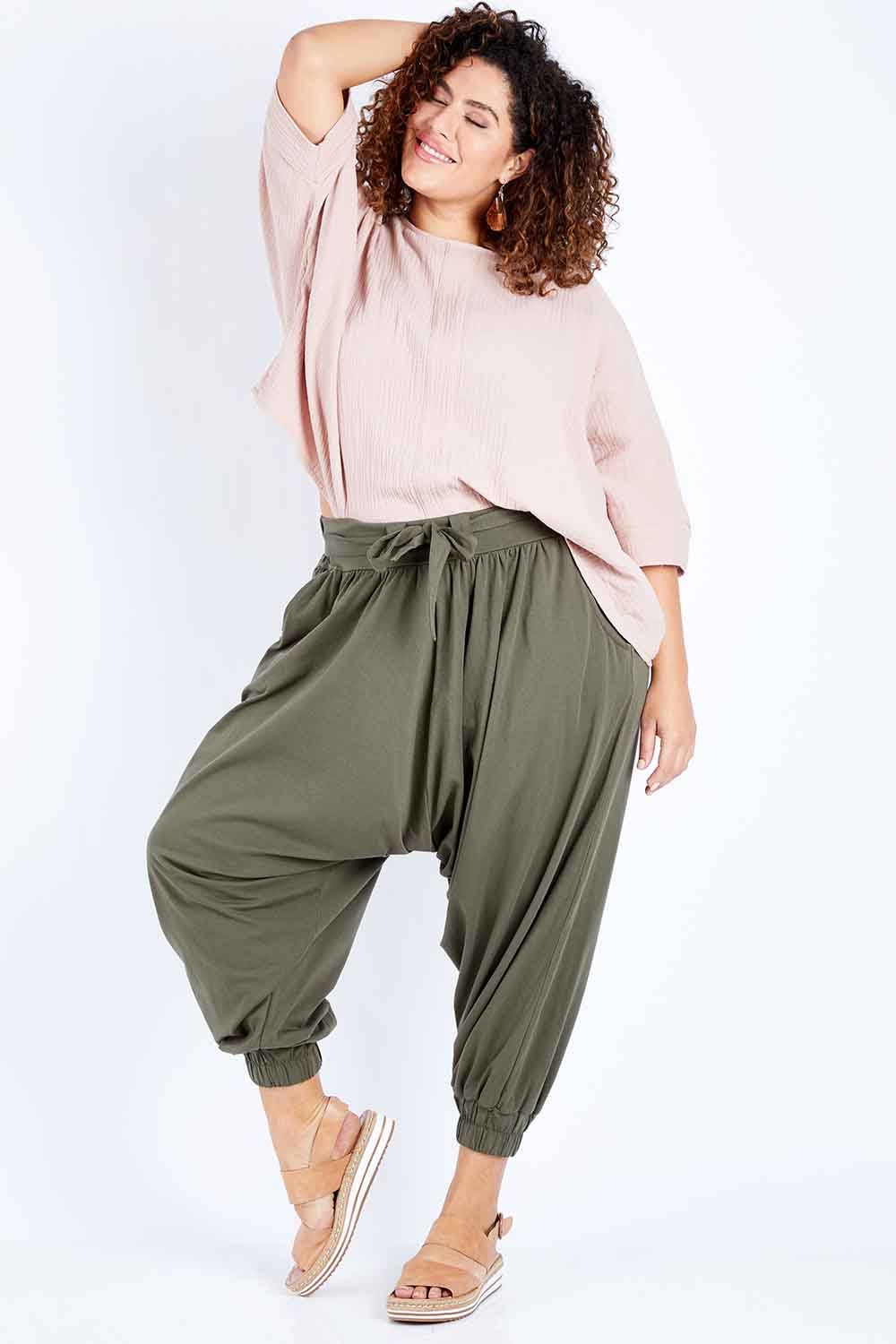 Model Jess wearing size 16 of the Flow With Me Cotton Slouch Top in colour Petal (Pink), from the front, showing the whole outfit