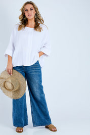 Model Jess wearing size 14 of the Flow With Me Cotton Slouch Top in colour White (White), from the front, showing the whole outfit