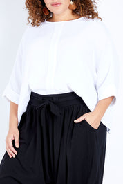 Model Jess wearing size 16 of the Flow With Me Cotton Slouch Top in colour White (White), from the front, cropped image