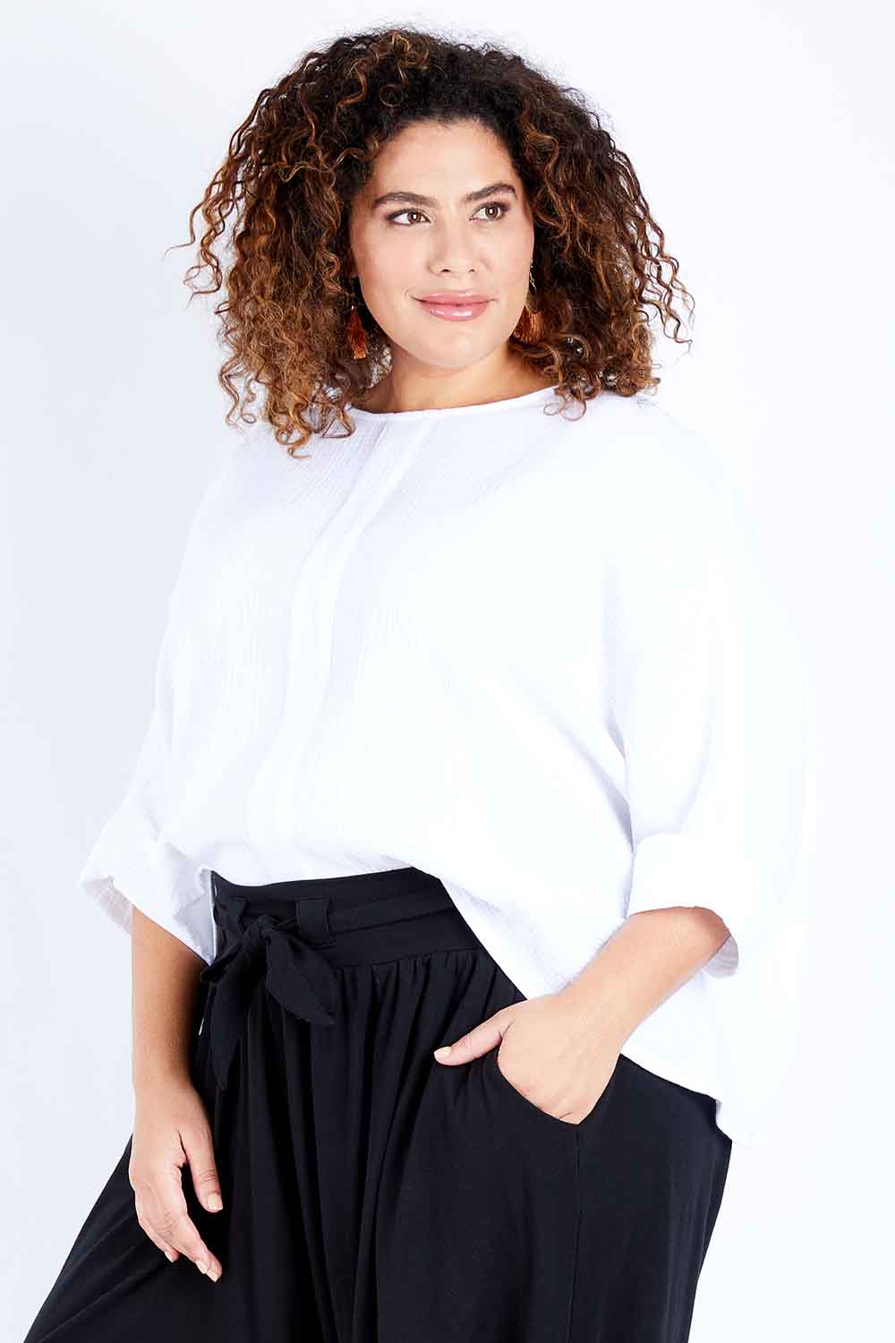 Model Jess wearing size 16 of the Flow With Me Cotton Slouch Top in colour White (White), from the front, cropped image