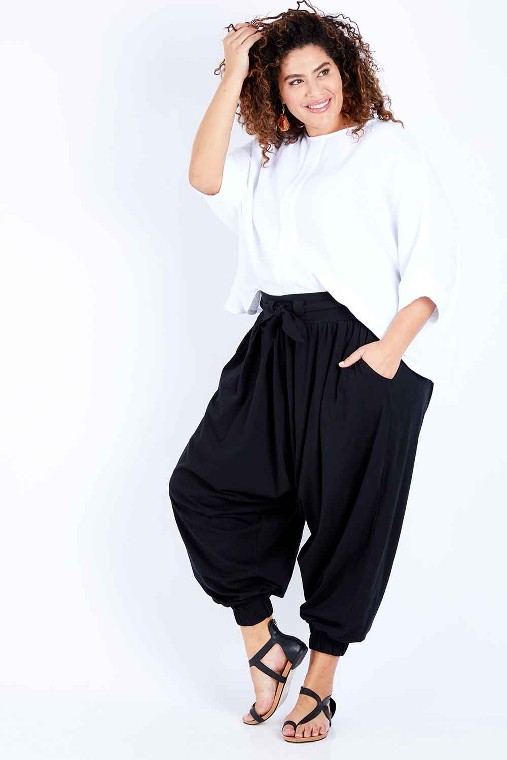 Model Jess wearing size 16 of the Flow With Me Cotton Slouch Top in colour White (White), from the front, showing the whole outfit