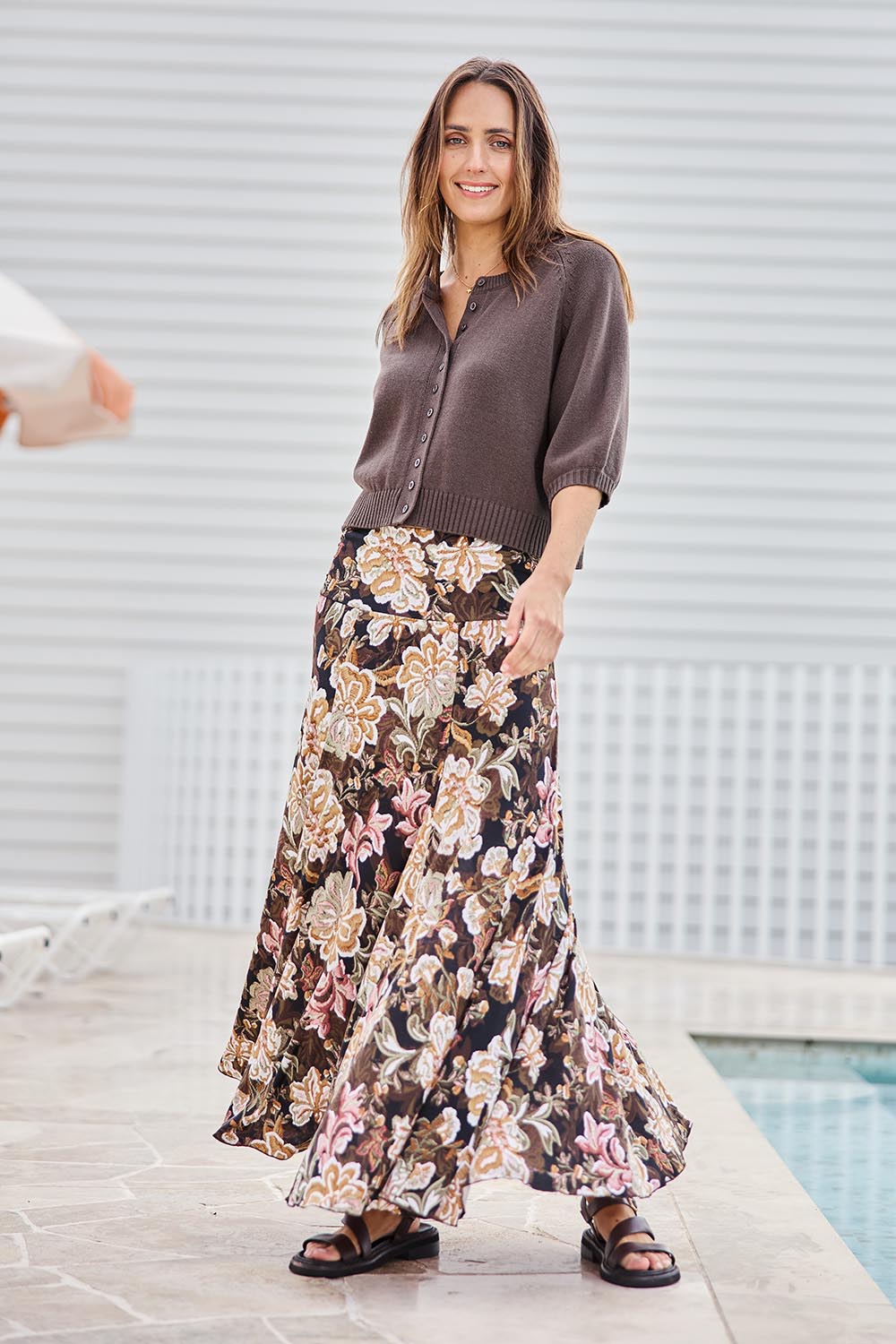 Model Tegand wearing size 10 of the The Wanderer In Me Printed Travel Skirt – Garden in colour Garden, from the front