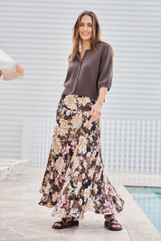 Model Tegand wearing size 10 of the The Wanderer In Me Printed Travel Skirt – Garden in colour Garden, from the front