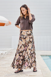 Model Tegand wearing size 10 of the The Wanderer In Me Printed Travel Skirt – Garden in colour Garden, from the front