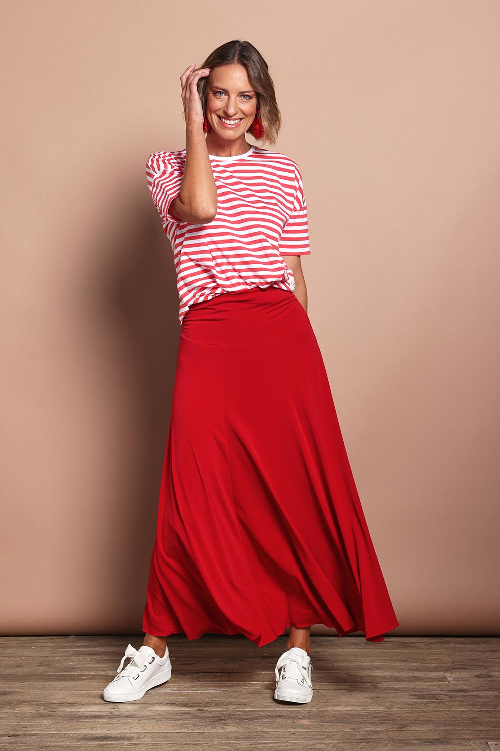 Model Riina wearing size 10 of The Wanderer In Me Travel Skirt in colour Redhot (Red), from the front, showing the whole outfit
