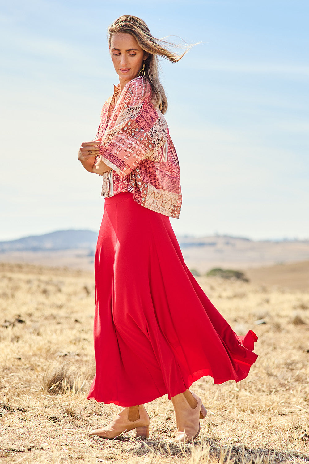 Model Tegan wearing size 10 of The Wanderer In Me Travel Skirt in colour Redhot (Red), from the front, showing the whole outfit