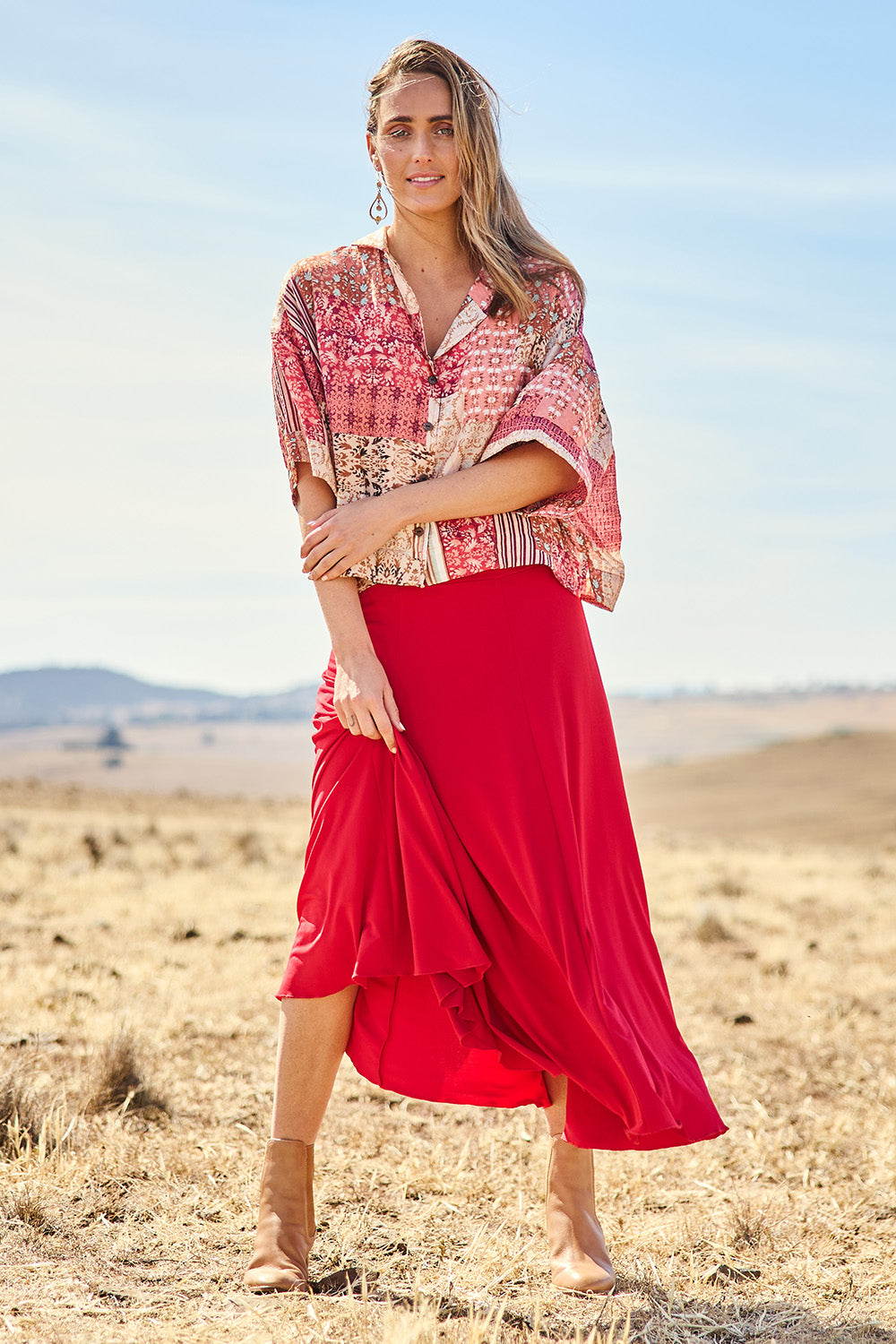 Model Tegan wearing size 10 of The Wanderer In Me Travel Skirt in colour Redhot (Red), from the front, showing the whole outfit
