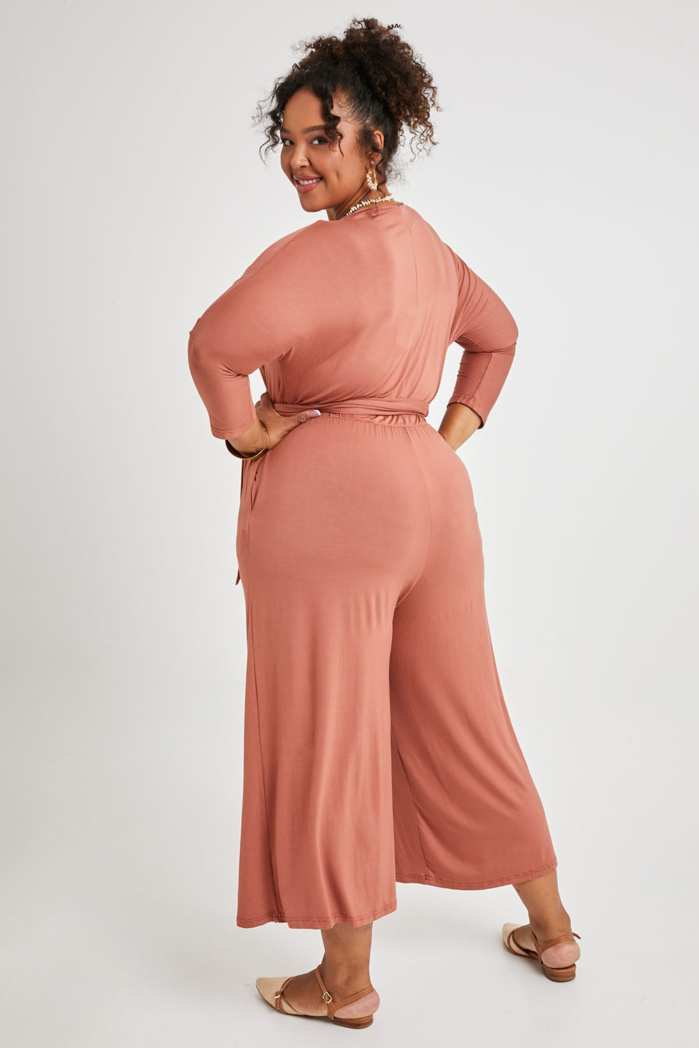 Model Alexis wearing size 16 of the Stylish Comfort Bamboo Jumpsuit in colour Copper, from the back