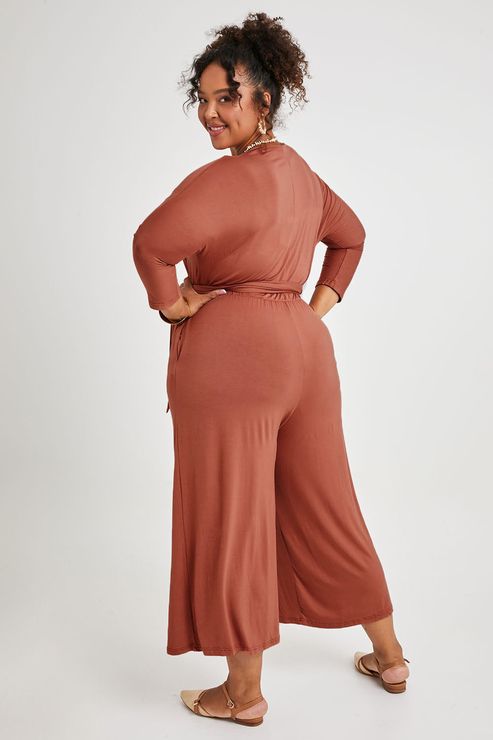 Model Alexis wearing size 16 of the Stylish Comfort Bamboo Jumpsuit in colour Copper, from the back