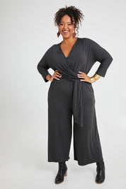 Model Alexis wearing size 16 of the Stylish Comfort Bamboo Jumpsuit in colour Storm (Black), from the front, showing the whole outfit