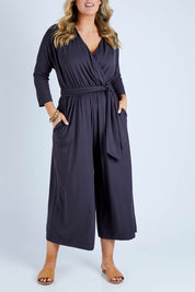 Model Jess wearing size 14 of the Stylish Comfort Bamboo Jumpsuit in colour Storm (Black), from the front, cropped image