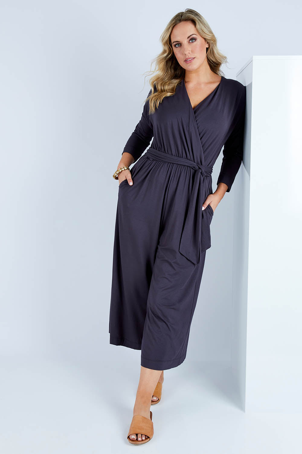 Model Jess wearing size 14 of the Stylish Comfort Bamboo Jumpsuit in colour Storm (Black), from the front, showing the whole outfit