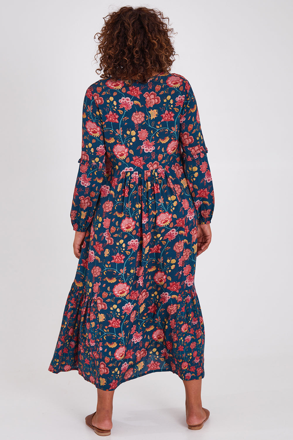 Model Anucia wearing size 14 of the Its Better With You Dress in colour Tealfleur (Blue), from the back