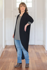 Model Katie wearing size 10 of the Falling For You Bamboo Cardi in colour Black (Black), from the front, showing the whole outfit