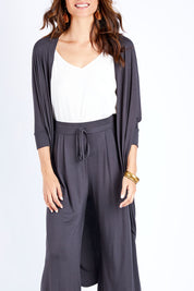 Model Ilona wearing size 10 of the Falling For You Bamboo Cardi in colour Storm (Black), from the front, cropped image