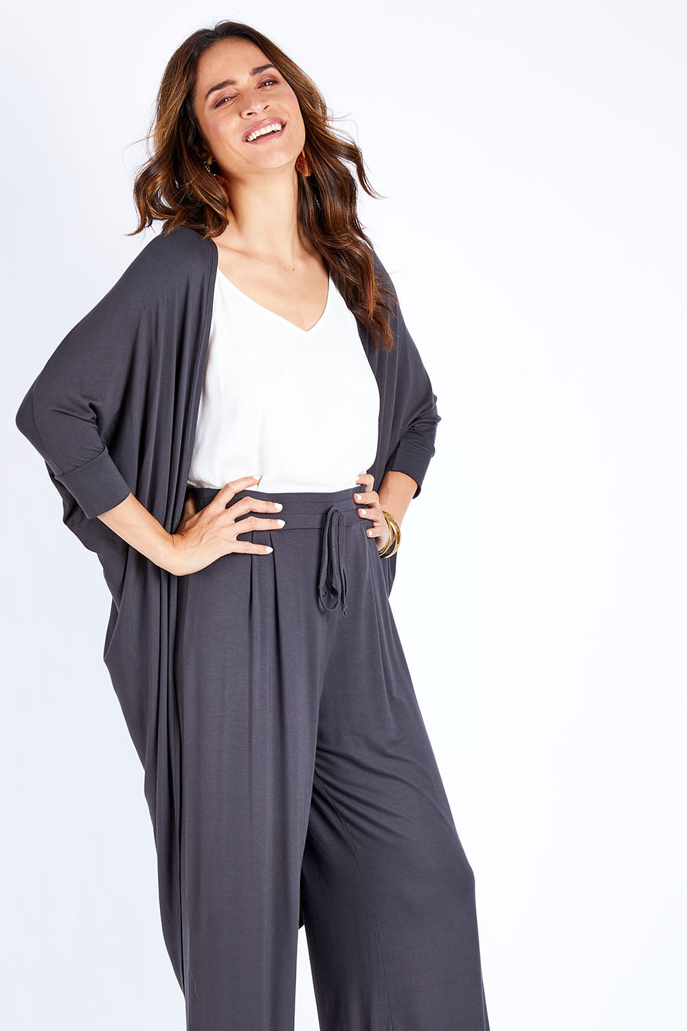 Model Ilona wearing size 10 of the Falling For You Bamboo Cardi in colour Storm (Black), from the front, cropped image