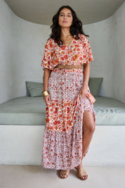 Model Tahnee wearing size 10 of the Tiers Of Joy Maxi Dress in colour Coralfleur, from the front, showing the whole outfit
