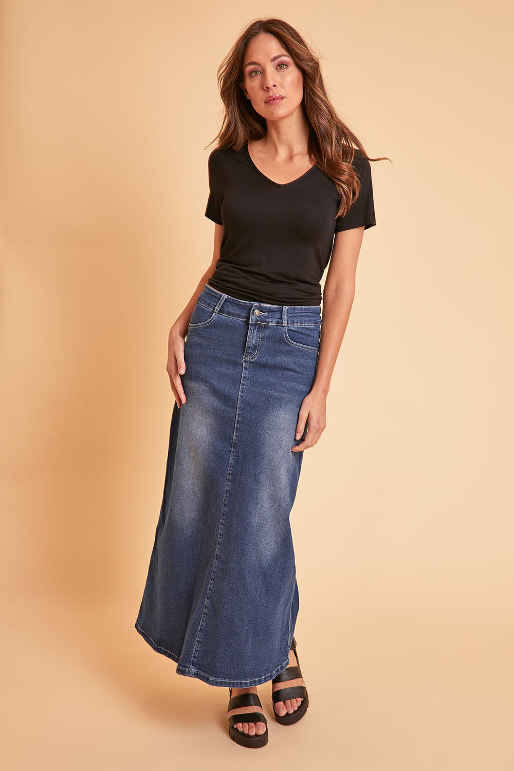 Model Madeline wearing size 10 of the Dusty Footprints Skirt in colour DarkDenim (Blue), from the front, showing the whole outfit