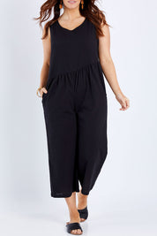 Model Laura wearing size 14 of the Turn Up The Heat Jumpsuit in colour Black (Black), from the front, cropped image