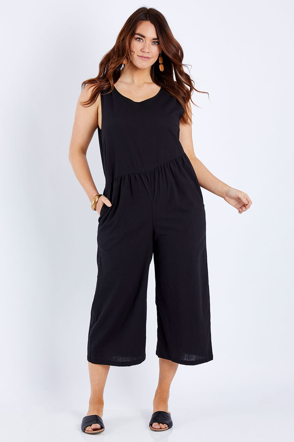 Model Laura wearing size 14 of the Turn Up The Heat Jumpsuit in colour Black (Black), from the front, showing the whole outfit