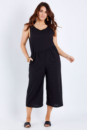 Model Laura wearing size 14 of the Turn Up The Heat Jumpsuit in colour Black (Black), from the front, showing the whole outfit