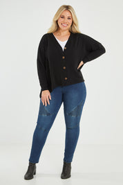 Model Katie wearing size 16 of the My Boyfriends Slouch Cardi in colour Black (Black), from the front, showing the whole outfit