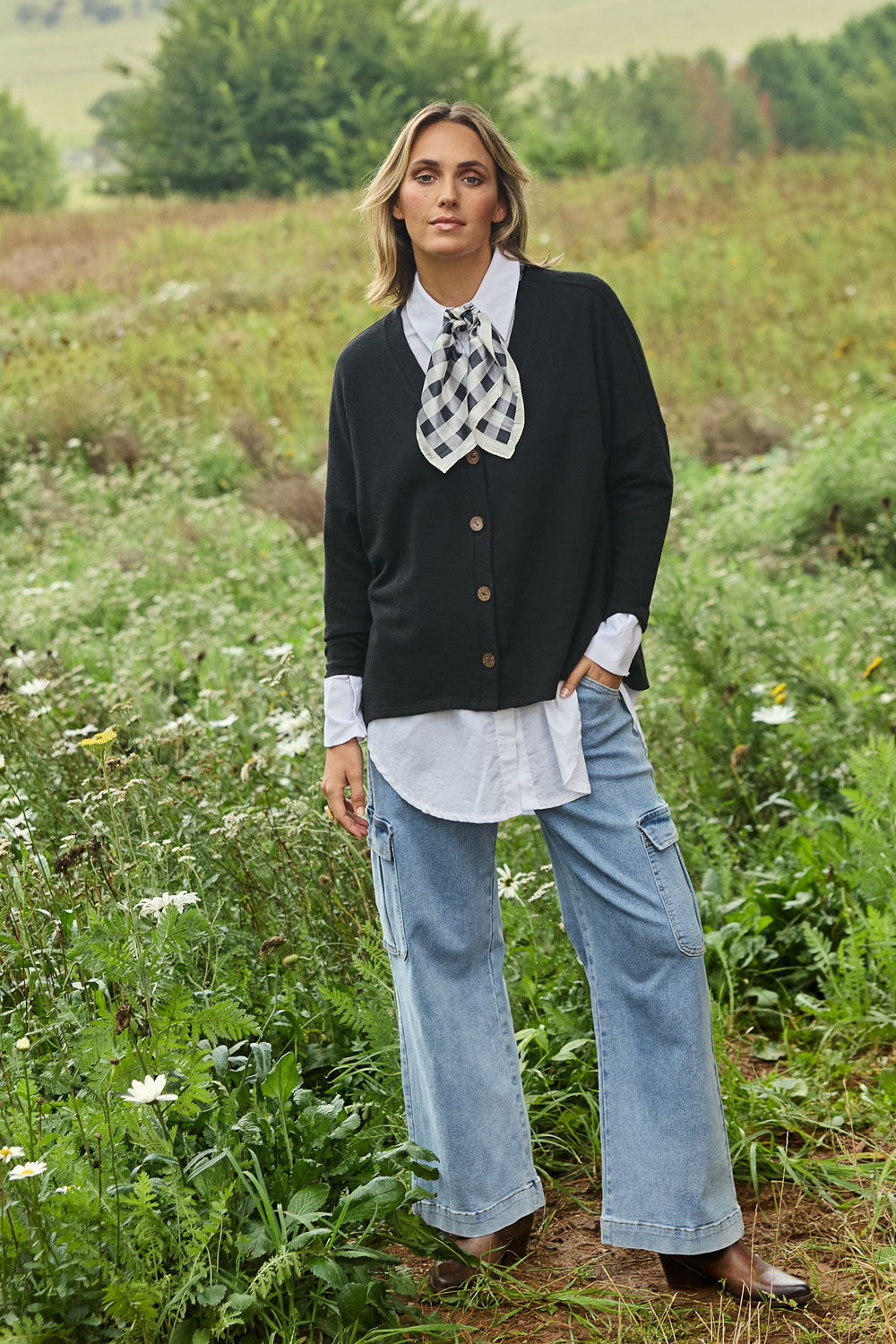 Model Tegan wearing size 10 of the My Boyfriends Slouch Cardi in colour Black (Black), from the front, showing the whole outfit