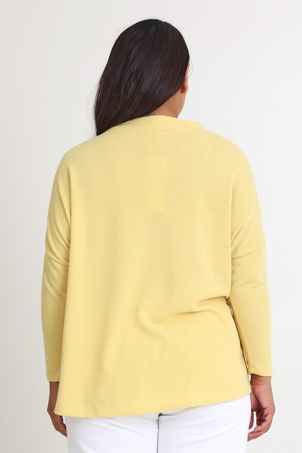 Model Ashleigh wearing size 16 of the My Boyfriends Slouch Cardi in colour Butter, from the back